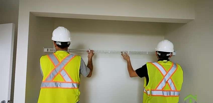 York installers marking out a closet opening in a suite at 37 Johnson Street